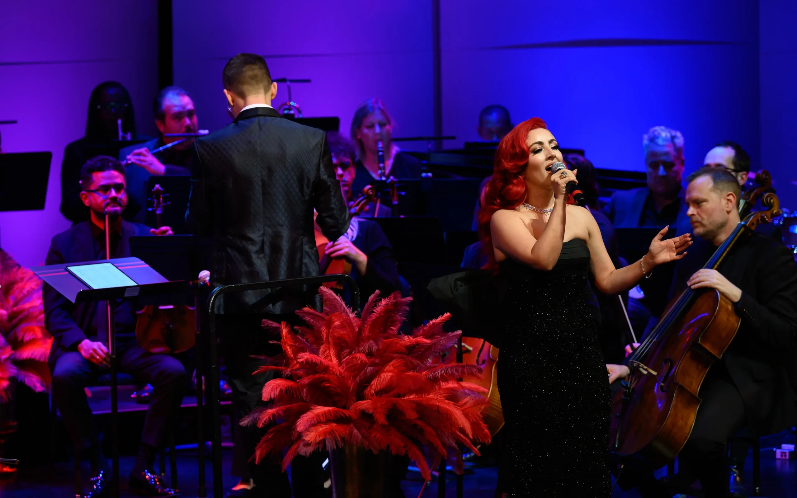Monique Abbadie singing while the orchestra surrounds her.